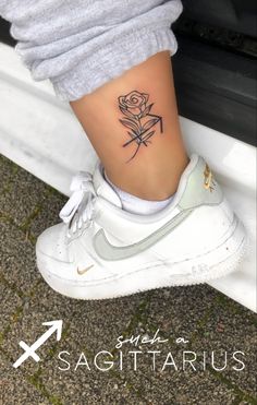 a woman's foot with a rose tattoo on her left leg and the words sagittatrus above it