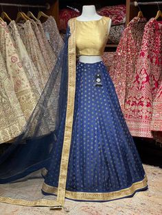 Space blue brocade skirt with gold blouse and net dupatta. Fabric: Georgette This outfit can be customized in multiple colors and specific to client measurements. 90 days of production time is required and are for bulk orders only! Orders are processed in store only! Final fittings/alterations not included. Minimum Order Quantity- 4 pieces Fitted Royal Blue Traditional Wear With Self Design, Royal Zari Work Sets For Party, Blue Chanderi Lehenga For Party, Fitted Blue Raw Silk Lehenga, Blue Banarasi Silk Set With Unstitched Blouse, Gold Brocade Lehenga For Festivals, Blue Raw Silk Lehenga For Festivals, Blue Raw Silk Choli For Festivals, Gold Brocade Sets With Unstitched Blouse