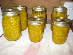 four jars filled with food sitting on top of a towel