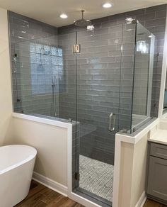 a bathroom with a tub, sink and shower stall in the middle of it's walls