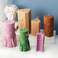 four different colored candles sitting next to each other