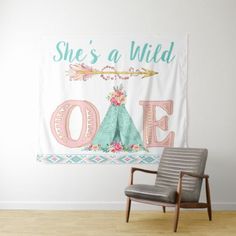 there is a chair in front of a wall with a sign that says she's a wild one