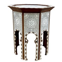 a white and brown table with an intricate design