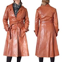 "Elevate your wardrobe with this 70s retro cognac brown leather trench coat by Skin Gear. The mid-length coat features a belted waist, long sleeves, and a variety of closures including tie and button options. Perfect for travel, party/cocktail events, casual wear, or business meetings, the coat is designed with a classic fit and is made with high-quality leather that is easy to maintain with leather cleaner.  The coat comes in XS/S size and is in a solid pattern with warm caramel brown color. It also has pockets for added convenience and a polyester lining material. This vintage piece is perfect for anyone who wants to add a touch of retro to their style. Made in Mexico, this trench coat is a must-have for any fashion-forward woman. Satin liner Butter soft leather Some marks as shown Pocke Belted Brown Long Coat Outerwear, Brown Belted Long Coat Outerwear, Brown Belted Long Coat, Belted Long Brown Coat, Retro Belted Fall Outerwear, Retro Belted Outerwear For Fall, Fitted Brown Belted Outerwear, Brown Leather Trench Coat, Leather Cleaner