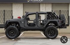 a black jeep parked in front of a building