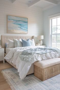 a large bed sitting in a bedroom on top of a wooden floor next to a window