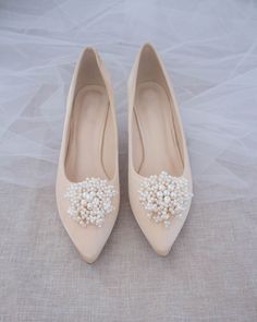 Perfect pointy toe heels with elegant mini pearls brooch is beautiful simplicity. Easy slip on with comfort for bride and wedding party. Detail: FIT: STYLE RUNS SMALL, ORDER HALF SIZE UP FROM YOUR REGULAR SIZE HEEL HEIGHT: 2 InchesCOLORS AVAILABLE: White, Ivory, and ChampagneUPPER: Synthetic upper and liningMATERIALS: Mandmade outsole Not sure of which size to purchase? Shoes measurements are as follow:(Please note measurements taken the length of inside of shoe from toe to heel)Size 5.5 - 9.5”S Bridal Veils And Headpieces, Wedding Aesthetics, White Champagne, Pointy Toe Heels, Bridal Veils, Betsey Johnson Shoes, Cute Flats, Satin Heels, Pearl Brooch