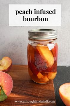 a jar filled with sliced peaches sitting on top of a wooden cutting board next to an apple