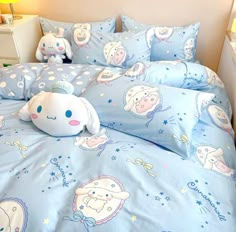 a bed with blue sheets and cartoon characters on it