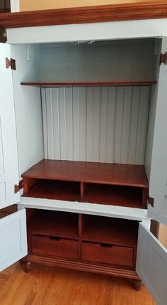 an empty room with some shelves and drawers