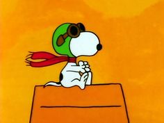 a cartoon dog sitting on top of a table with a red scarf around his neck