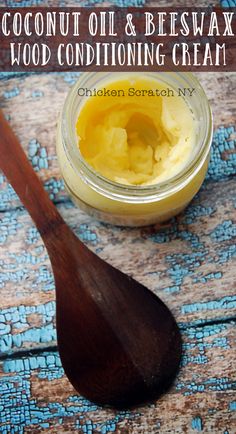 a wooden spoon and jar filled with homemade wood conditioning cream on top of a table