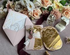 a table topped with lots of different types of wedding cards and flowers on top of it