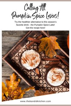 two cups of pumpkin spice latte on a tray with autumn leaves and cinnamon sticks