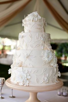 a white wedding cake sitting on top of a table