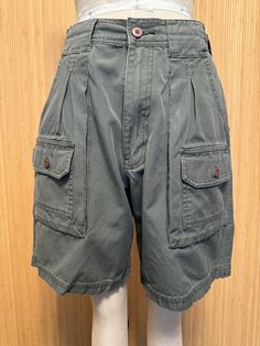 These great-looking vintage shorts feature multiple pockets front and back, a high rise and zip fly. No labels whatsoever.  Very good vintage condition. Feels like cotton or cotton blend.  Detailed Measurements: Waist - 28 inches  Hip - 39 inches  Rise - 12 inches  Inseam - 7.5 inches Utility High-waisted Cargo Shorts With Belt Loops, Outdoor Bermuda Shorts With Pockets, Military Style Shorts For Outdoor With Pockets, Utility High-waisted Cargo Shorts With Patch Pockets, High-waisted Utility Cargo Shorts With Patch Pockets, High-waisted Cargo Shorts With Patch Pockets, Military Style Short Bottoms With Pockets, Military Style Shorts With Pockets, Outdoor Cotton Shorts With Belt Loops