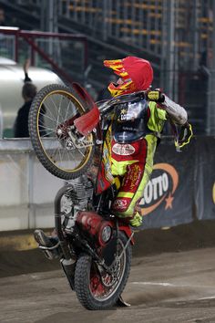 a man riding on the back of a dirt bike