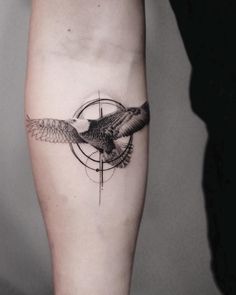 a black and white photo of a bird on the arm with an arrow in it