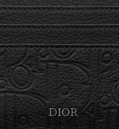 The card holder is a practical piece with refined charm. Displaying the virtuosity of the House ateliers, the Dior Gravity leather showcases the iconic motif delicately embossed on black calfskin. The style features three card slots on either side as well as a central top slot to store personal effects. The elegant card holder will slip easily into any pocket.. Dior Atelier, Dior Star, Icon Shoes, Dior Book Tote, Elegant Cards, Wallet Pouch, Backpack Tote Bag, Silver Cufflinks, Beach Accessories