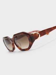 Featuring a classy tortoiseshell design, geometric lenses and a sleek silhouette, these Gabine sunglasses are the accessory you should be adding to your collection right now. The functional and chic tinted lenses add to the vintage allure that complements the overall aesthetic, while offering protection from harmful UV rays. The little Gabine buckles on the sides add a sophisticated touch of shine. Design Geometric, Charles Keith, Oval Sunglasses, Uv Rays, Tortoise Shell, The Vintage, Right Now, Lenses, Recycling