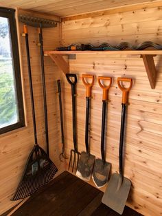 there are many different types of gardening tools hanging on the wall next to each other