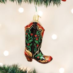 a cowboy boot ornament hanging from a christmas tree