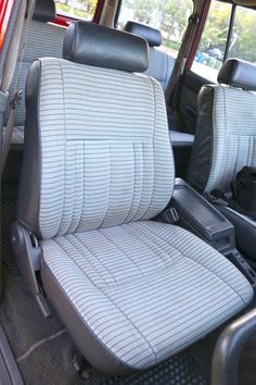 the interior of a vehicle with grey seats