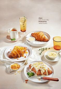 there are three plates with croissants and other food items on the table