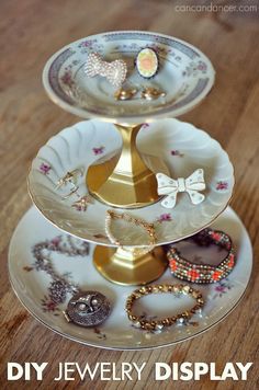 three tiered trays with jewelry on them sitting on a wooden table next to the words diy jewelry display