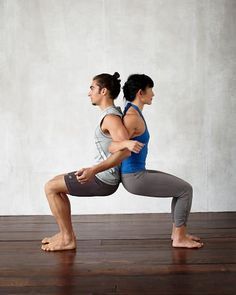 a man and woman doing yoga poses in front of a white wall, with their hands behind their backs