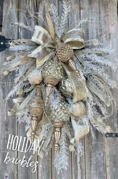 a holiday wreath with bells and snowflakes hanging on a wooden fence, ready to be hung