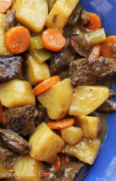 a blue plate topped with meat and vegetables