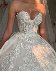 a woman in a wedding dress is posing for the camera