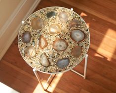 a table topped with lots of different types of rocks on top of a wooden floor