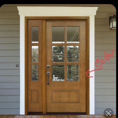 a wooden door with glass on the side of a house