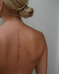 the back of a woman's neck with writing on her left shoulder and right arm