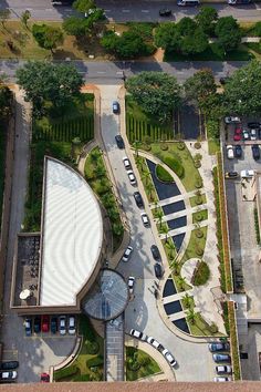 an aerial view of a parking lot with cars parked in it