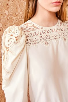 Made from our luxurious Victorian cotton-silk, the Aura Blouse is adorned with intricate Battenberg lace panels that create a decorative floral pattern along the yoke and sculptural long sleeves. It is a timeless pearly white, has a relaxed fit, and fastens with a buttoned keyhole at the back. Composition: 70% Cotton, 30% Silk Pair with our Lou Jean and Mini Floret Stud to complete the look. Explore more from our Victorian Cotton Silk Lace Collection. Battenberg Lace Pattern, Timeless Pearly, Aw 23, Battenberg Lace, Nyc Boutiques, Lace Collection, Lace Blouse Long Sleeve, Embellished Blouse, Silk Lace