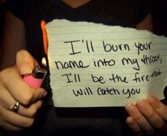 a person holding a piece of paper that says i'll burn your name into my fridge