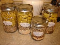 four jars filled with macaroni and cheese