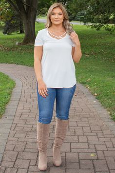 This solid white/ivory top is perfect for layering during the fall or winter and is going to be your go to basic ivory/white tee for any occasion. With a criss cross  neckline, this women’s blouse is going to be your favorite! Click to shop now! #womenscasualfashion #crisscross #winteroutfits #falloutfits #springoutfits #summeroutfits Trendy V-neck Top With Crisscross Straps, Casual Tops With Crisscross Straps For Day Out, Crisscross Top For Day Out In Spring, Spring Versatile Crisscross Tops, Versatile Spring Crisscross Tops, Versatile Crisscross Tops For Spring, Casual Tops With Crisscross Straps, Casual Stretch Crisscross Top, Stylish Top