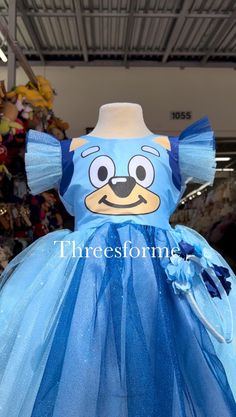 a dress made to look like an angry bird with blue tulle skirt and headband