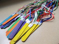 a bunch of colorful toothbrushes sitting on top of a counter