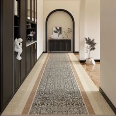 the hallway is clean and ready for guests to use it as an entrance way in this home