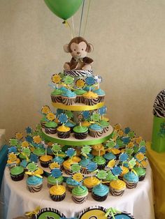 a table topped with lots of cupcakes and cakes