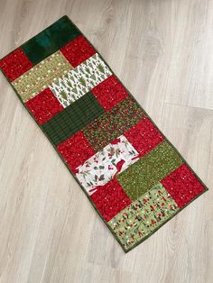 a red and green patchwork rug on the floor