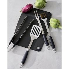 the kitchen utensils are laying out on the cutting board next to each other