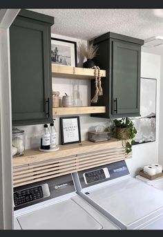 a washer and dryer in a small room with green cupboards on the wall