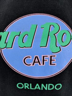 the logo on the back of a black shirt that says hard rock cafe orlando