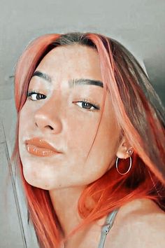 a woman with pink hair and hoop earrings